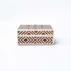 Brown and white geometric inlay box on a white background