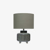 Blue stoneware table lamp with footed base and khaki green linen Shade on a white background
