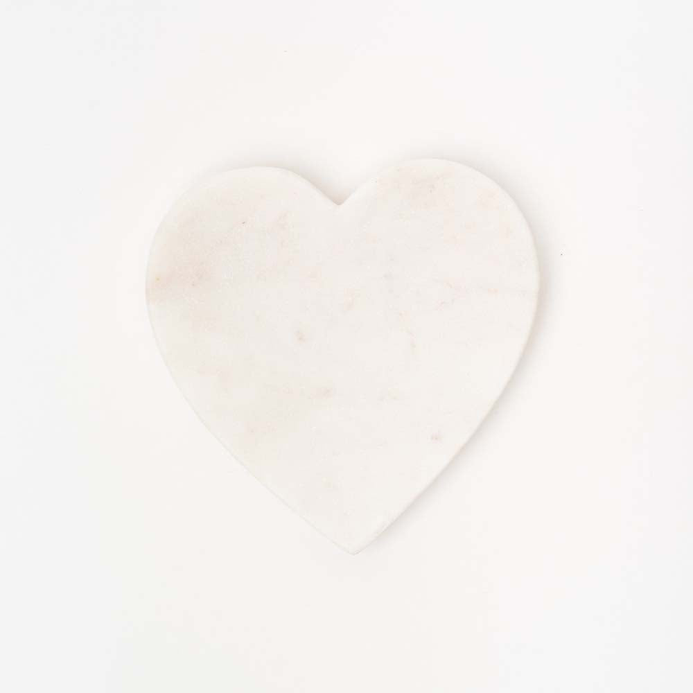 Small white marble heart dish on a white background