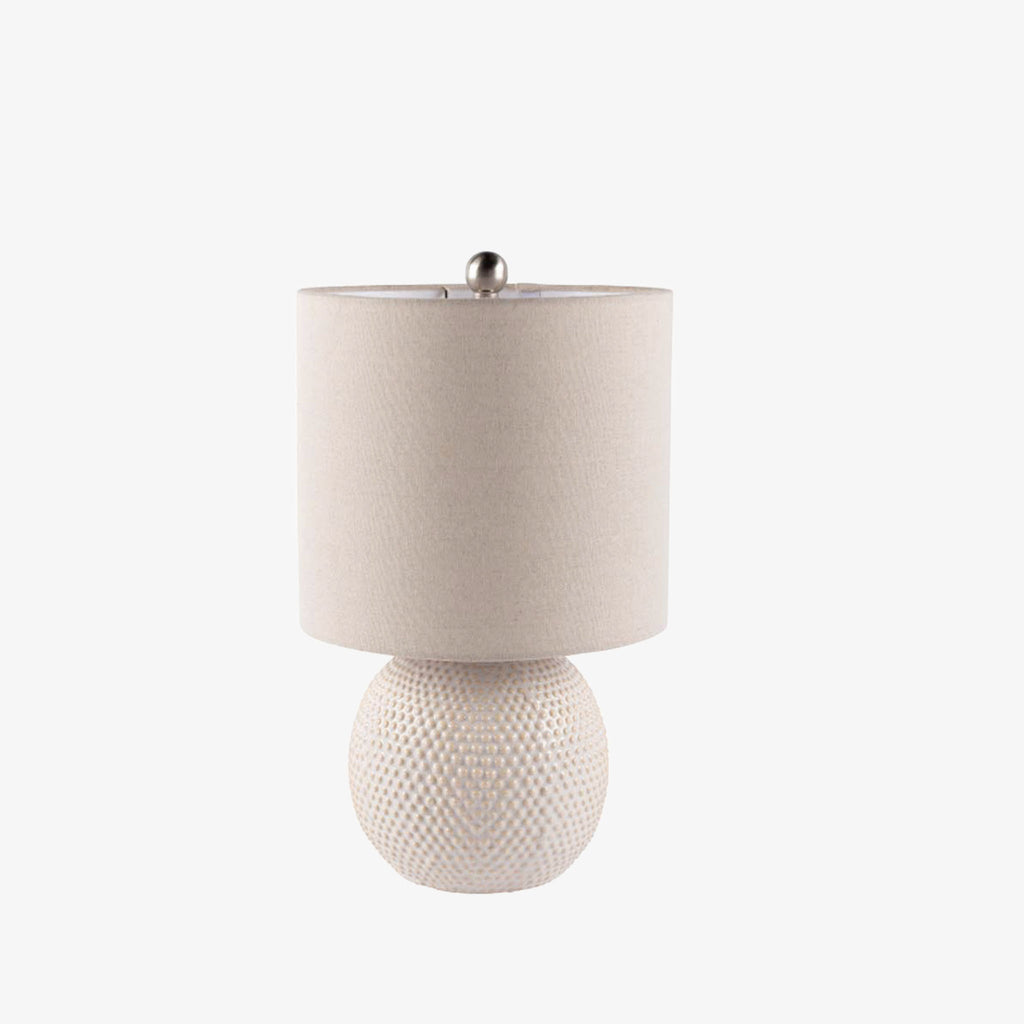 Surya Dragon round white table lamp with linen shade on a white background