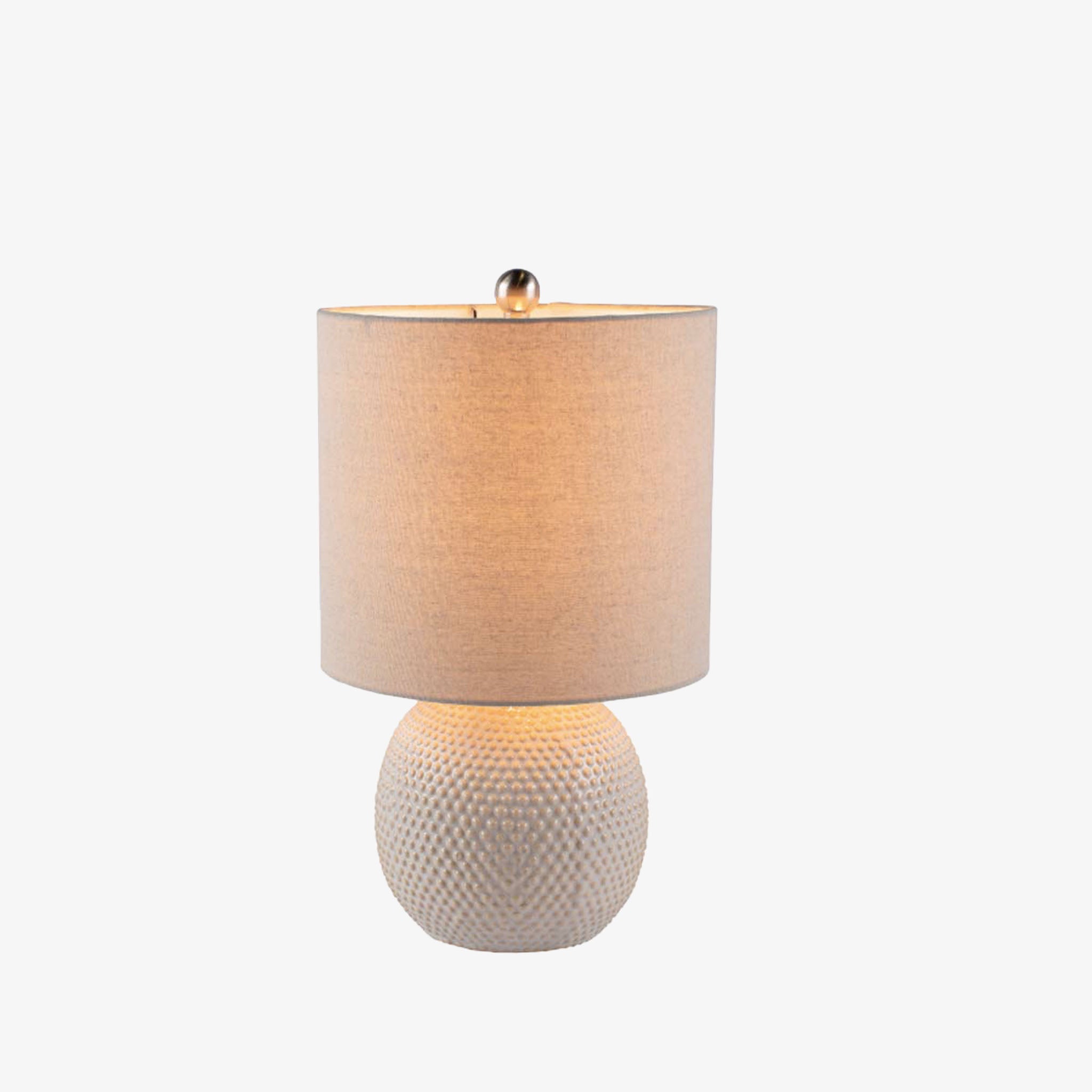 Surya Dragon round white table lamp with linen shade on a white background