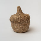 Small seagrass baskets with lid that look like an acorn on a white background
