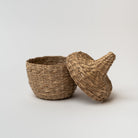 Small seagrass baskets with lid taken off on a white background