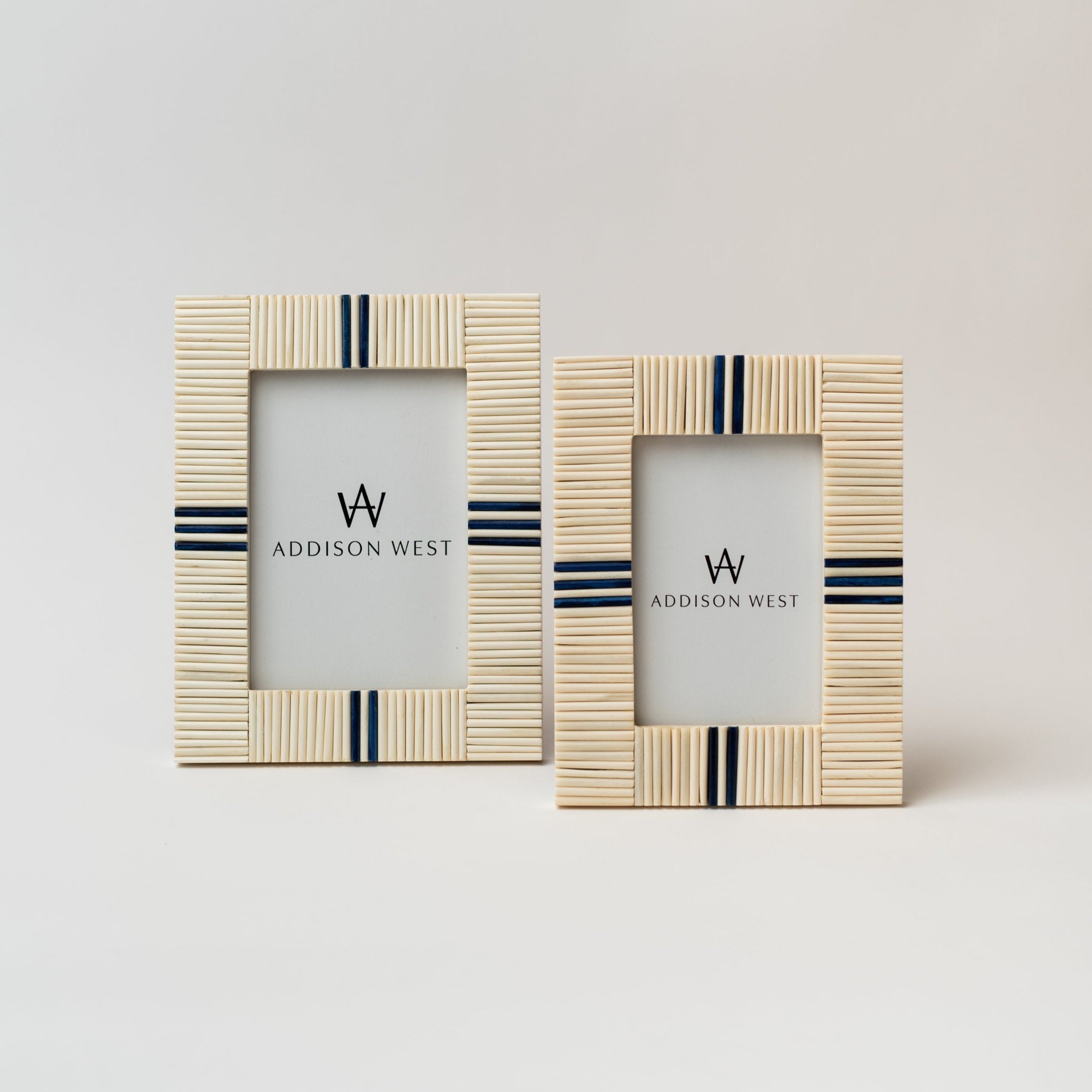 Two picture frames with bone inlay and navy blue accents on a white background