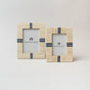 Two picture frames with bone inlay and navy blue accents on a white background