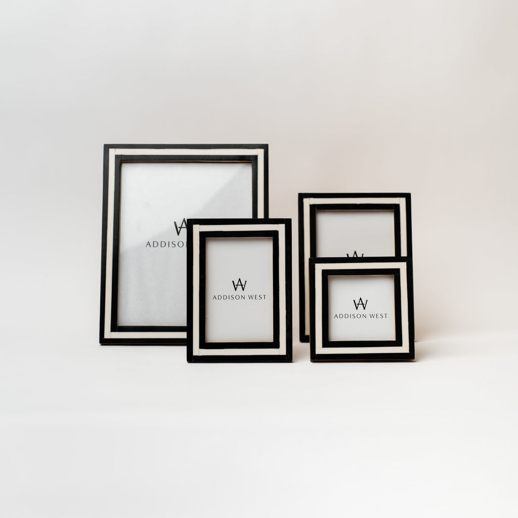 Four black and white picture frames on a white background