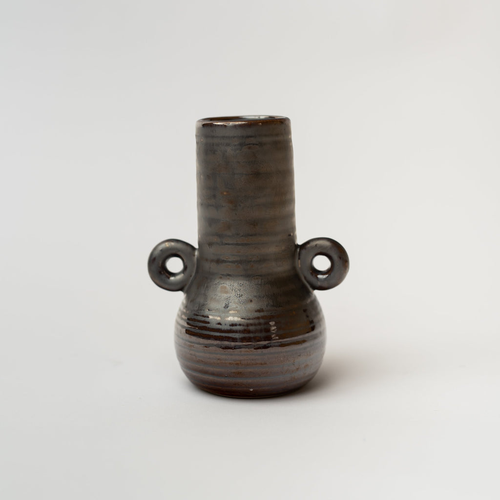 Black bud vase with loop accents on a white background