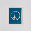 Swedish cloth with blue background and white peace sign on a white background
