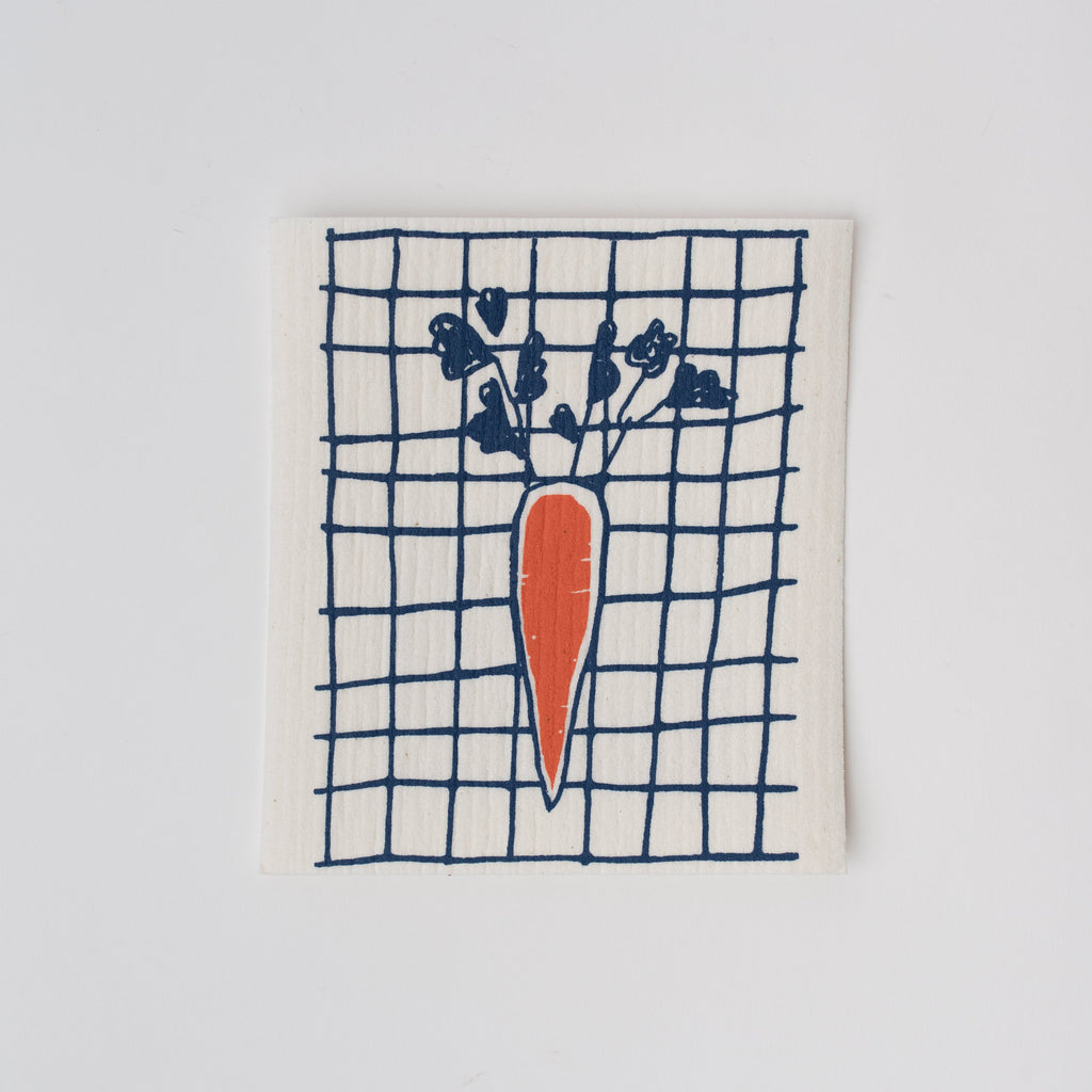 Swedish cloth sponge with carrot and blue grid on a white background