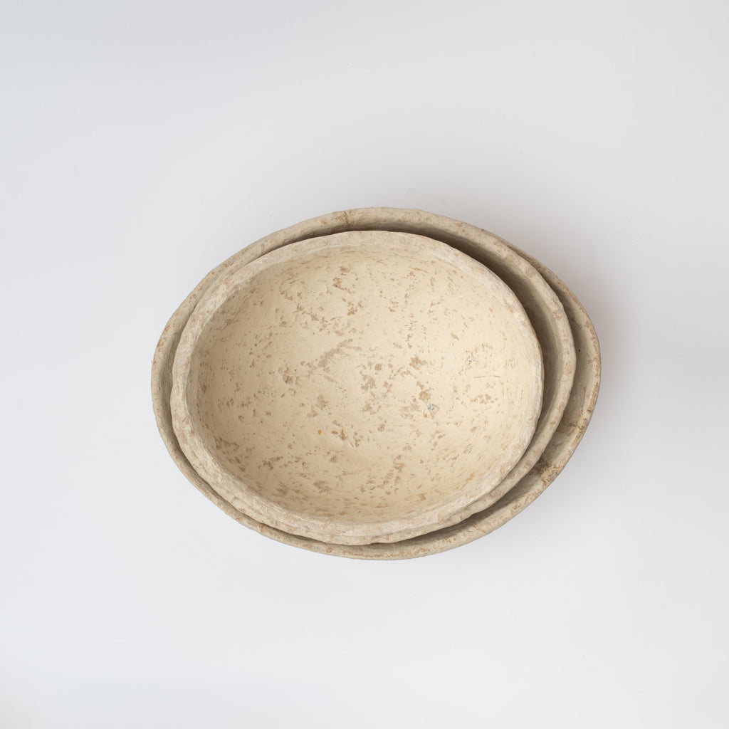 Three nested paper mache bowls on a white background viewed from above
