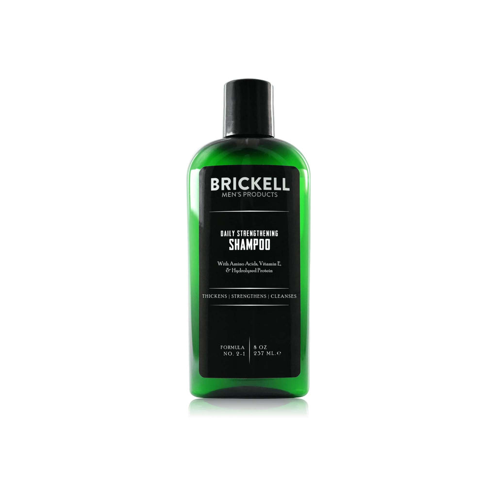 Brickell brand daily strengthening men's shampoo in green bottle with black label on a white background