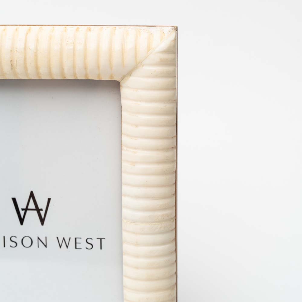 Close up of White picture frame for 4x6 photo on a white background. 