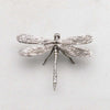 Close up of antique pewter dragon fly by Zodax on a white background