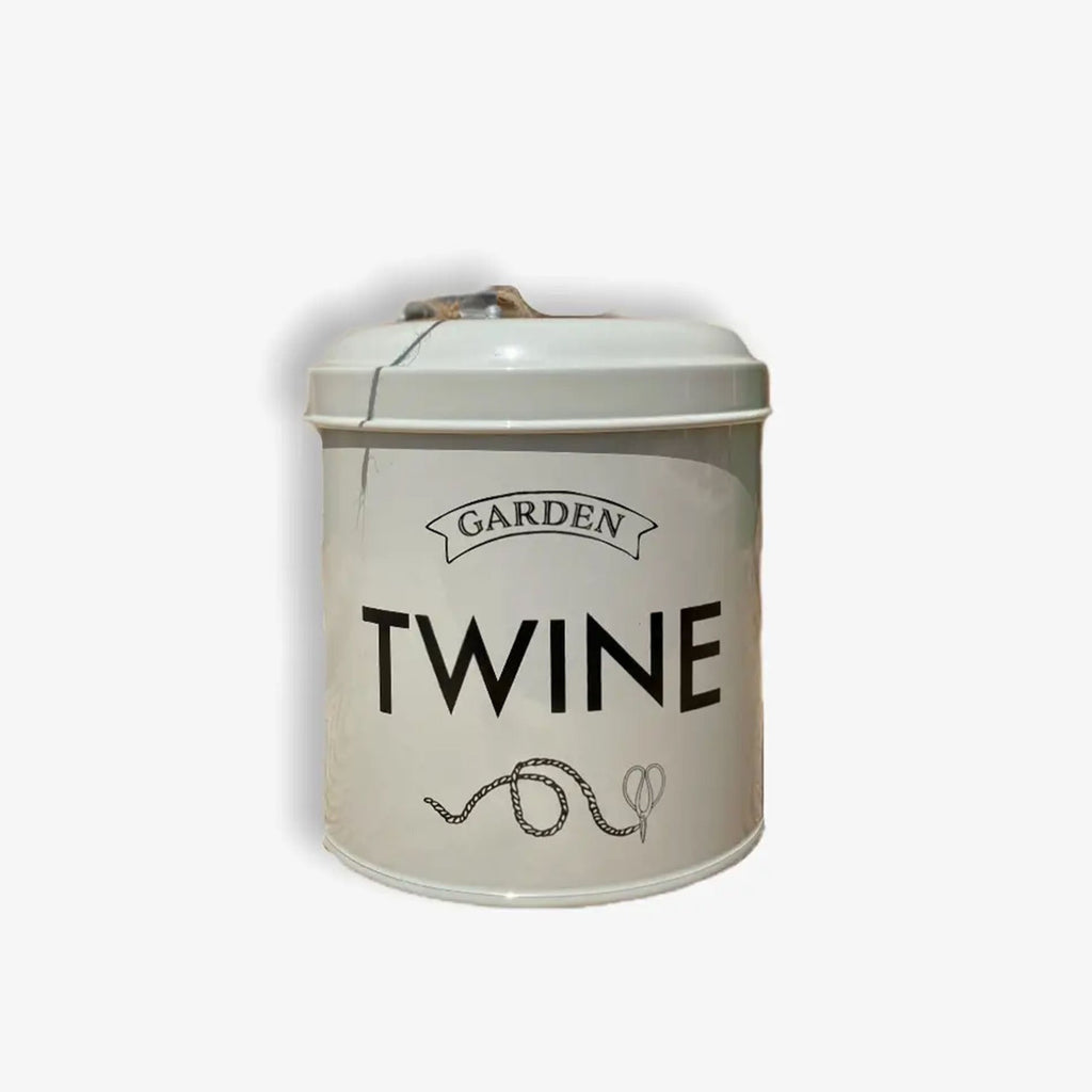 White tin dispenser with lid that says garden twine on front in black letters on a white background