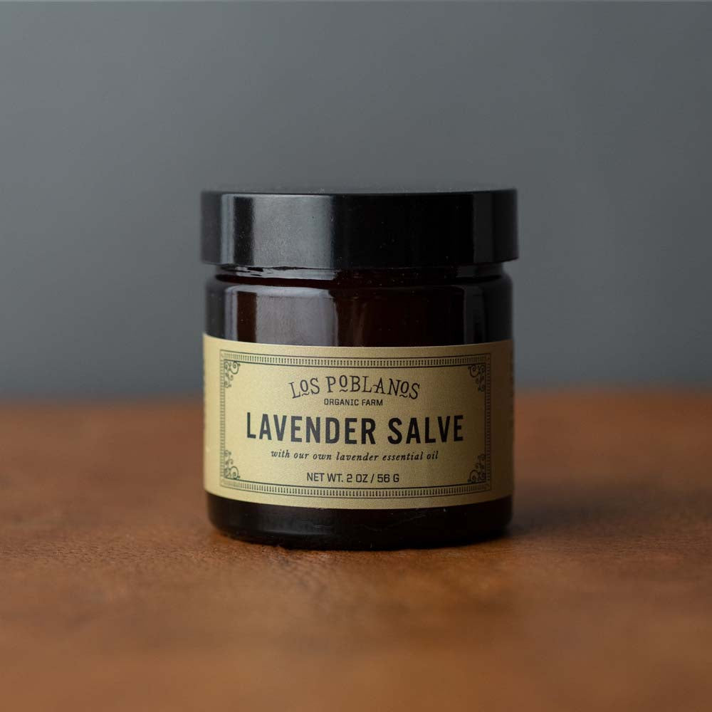Los Poblanos brand lavender salve jar on a wood counter