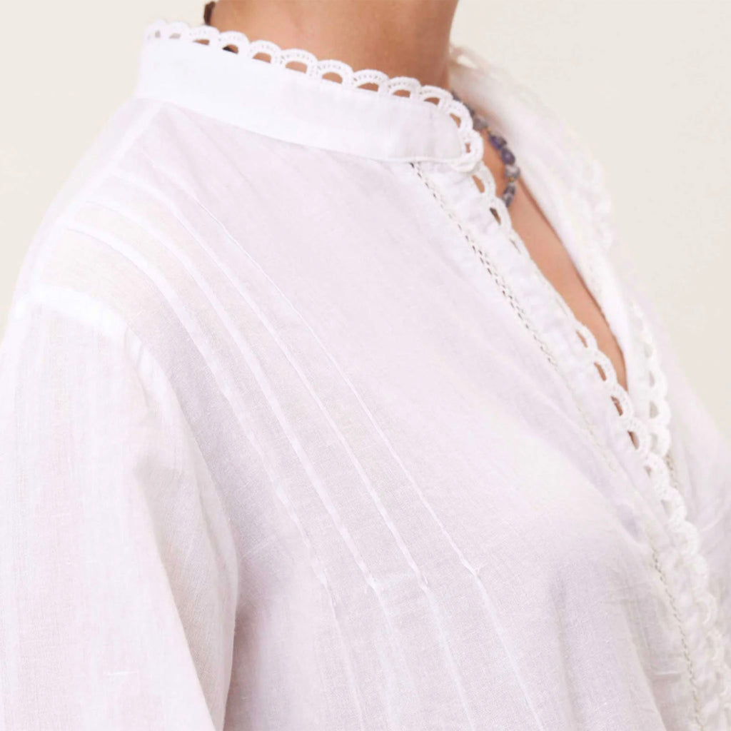 Close up of white light weight cotton top with pin tuck details on model
