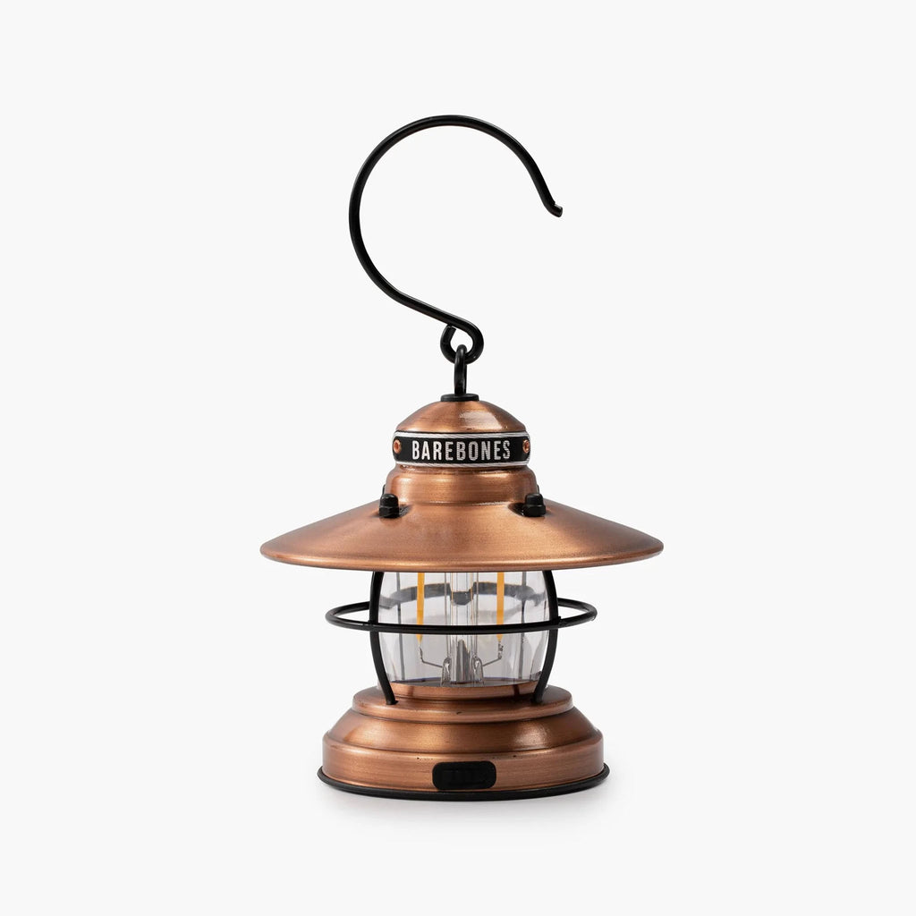 Barebones brand mini Edison lantern with vintage style and caged bulb in copper on a white background