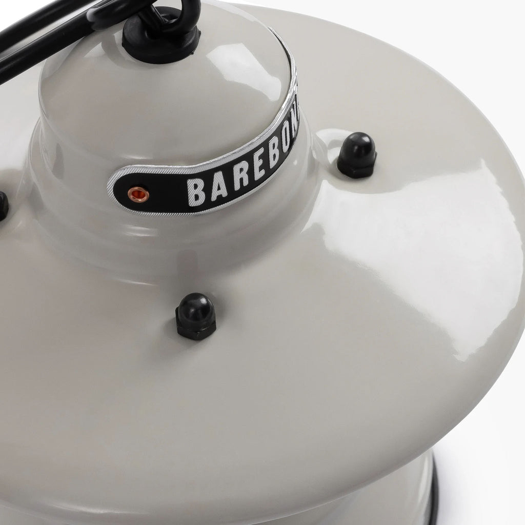 Close up of White mini Edison lantern by Barebones brand with vintage style and caged bulb on a white background