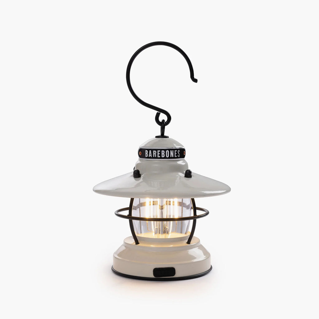 White mini Edison lantern by Barebones brand with vintage style and caged bulb on a white background