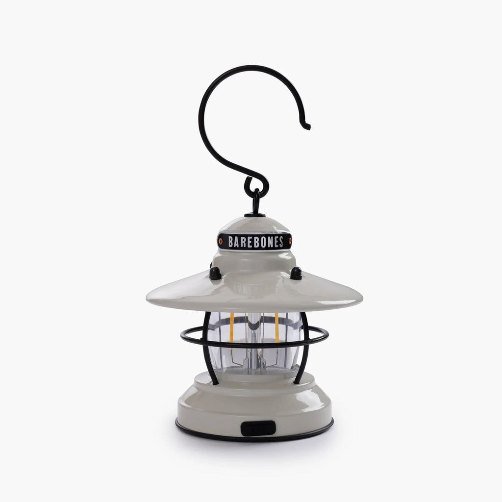 White mini Edison lantern by Barebones brand with vintage style and caged bulb on a white background