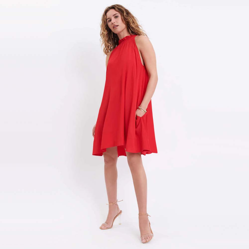 Model wearing Mersea brand endless summer dress in poppy
