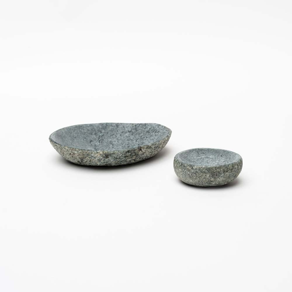Large and small stone bowls on a white background