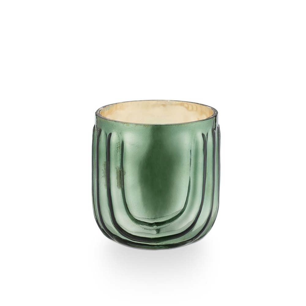 Illume green pressed glass balsam and cedar candle  on a white background