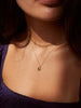 Model wearing Able brand Fortune cookie necklace in 14 carat gold fill 