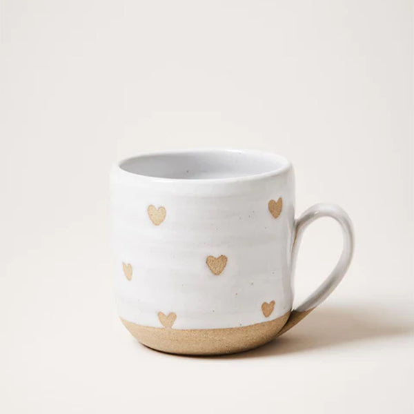 Farmhouse Pottery brand confetti heart mug  on a white surface