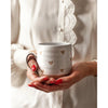 Farmhouse Pottery brand confetti heart mug being held by a model with red nails 