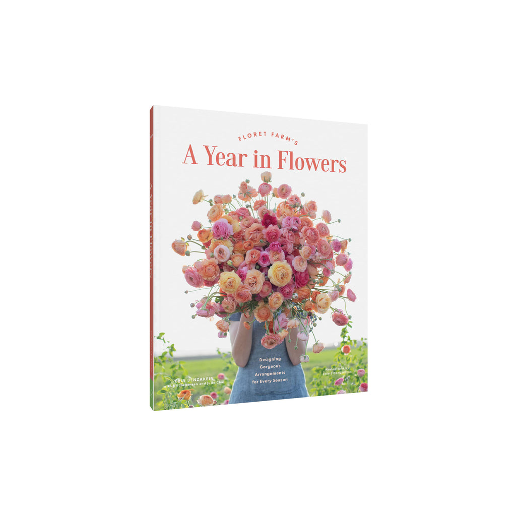 Cover of book titled 'Floret Farm's a Year in Flowers' with women holding large bouquet of pink and orange flowers in a white background