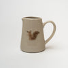 Small pitcher with squirrel painted on front on a white background