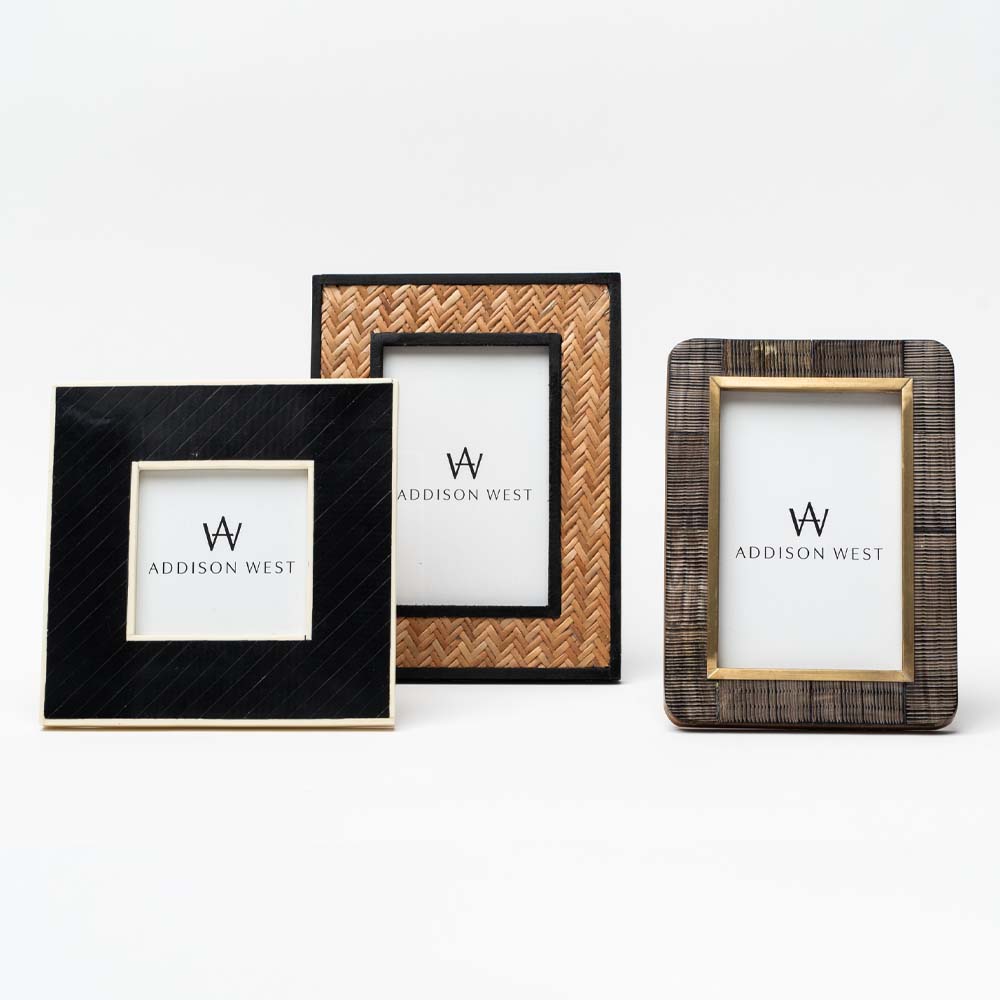 Three picture frames in black and brown materials on a white background