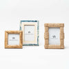 Collection of 3 picture frames in wood and rattan on a white background