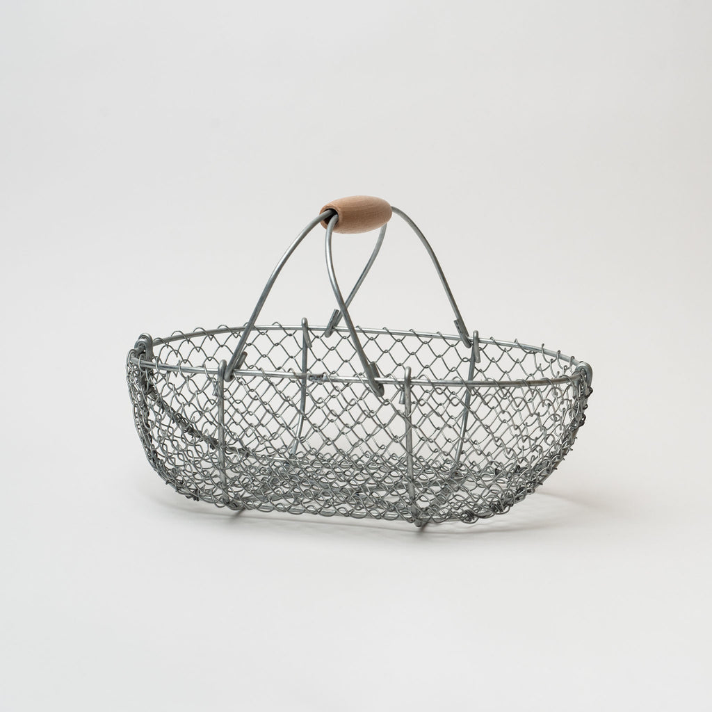 Wire basket with wood handle on a white background