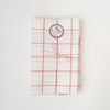 Set of two red plaid Tissage de L’Ouest tea towels with made in france sticker on a white background