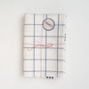Set of two blue plaid Tissage de L’Ouest tea towels with made in France sticker on a white background