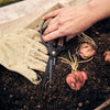 Person holding Barebones brand garden shears with ambidextrous black and wood handle in garden