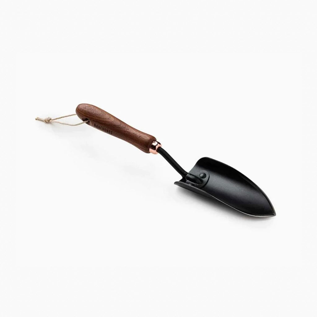 barebones brand garden trowel with wood handle on a white background