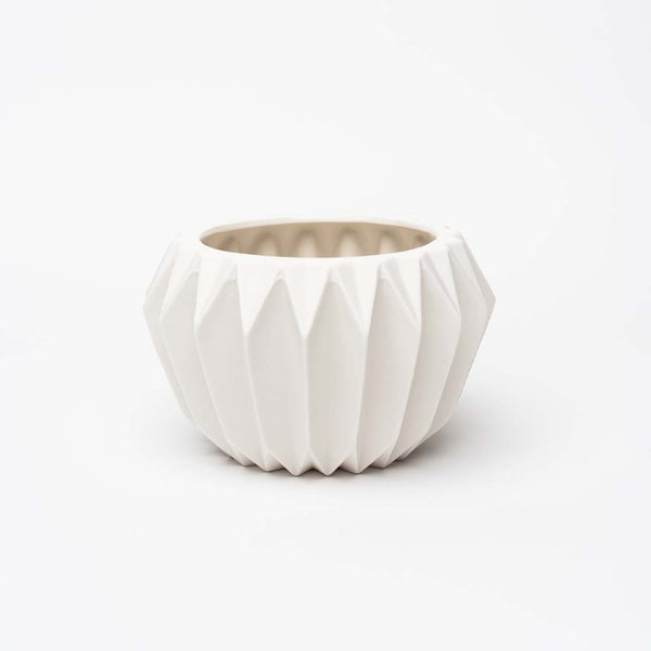 White stoneware planter with fluted sides on a white background 