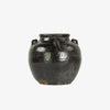 Brownish black urn with four hands on a white background