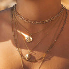 Model wearing Scream Pretty brand gold zodiac star sign necklace
