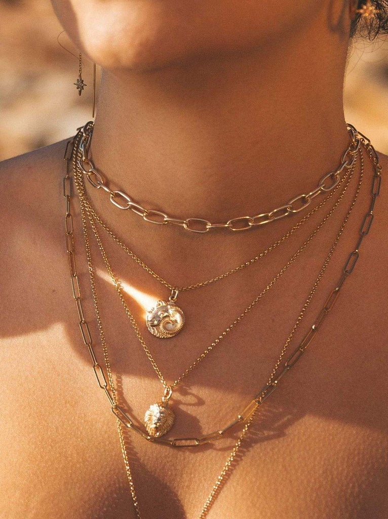 Model wearing Scream Pretty brand gold zodiac star sign necklace