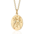 Scream Pretty brand gold Gemini zodiac star sign necklace on a white background