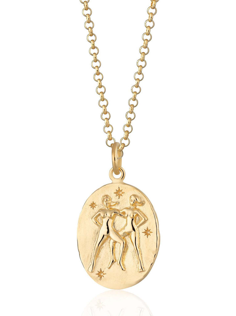Scream Pretty brand gold Gemini zodiac star sign necklace on a white background