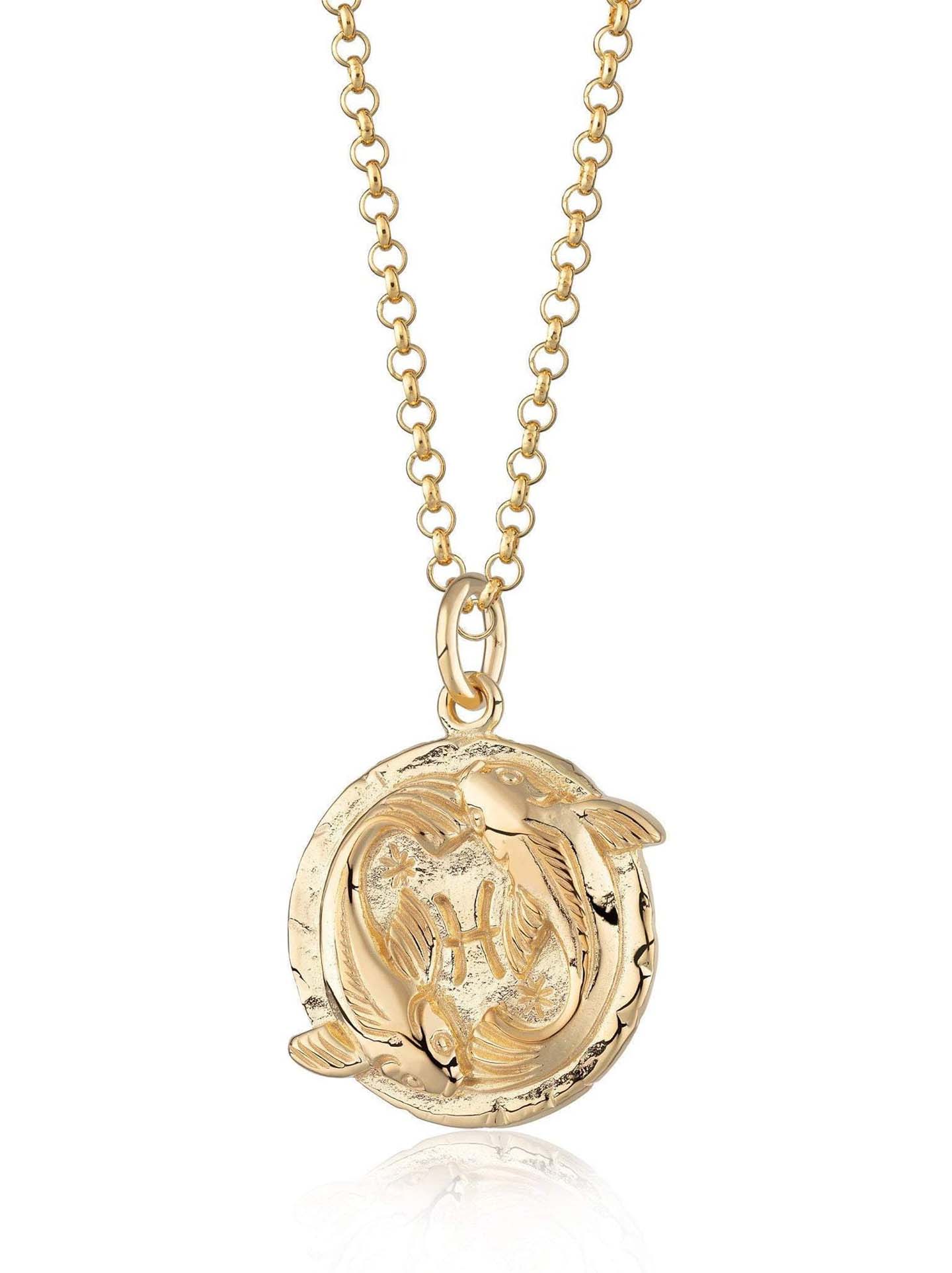 Scream Pretty brand gold Pisces zodiac star sign necklaces on a white background