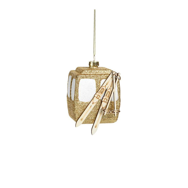 Gold gondola ornament with skis and gold glitter on a white background