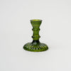 Green pressed glass candle stick on a white background