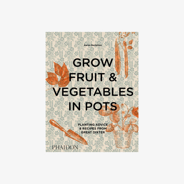 Front cover of book titled 'grow fruit and vegetables in pots' with blue pattern and organge vegetables on a white background 