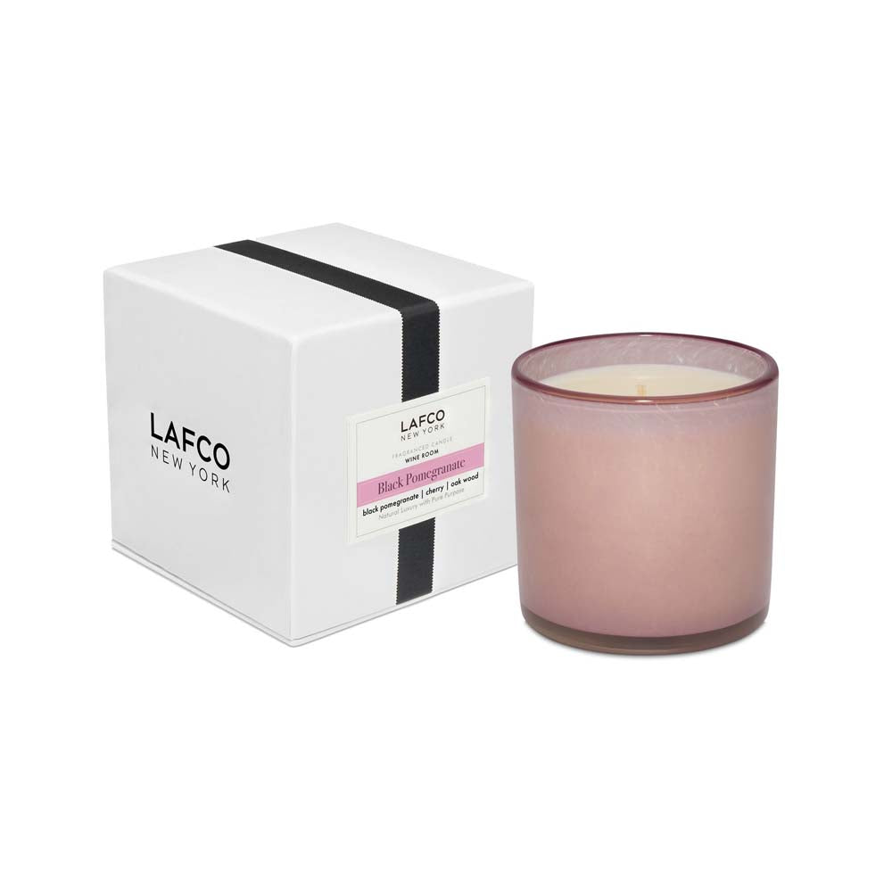 Lafco brand 'black pomegranate' glass candle in a rose glass vessel